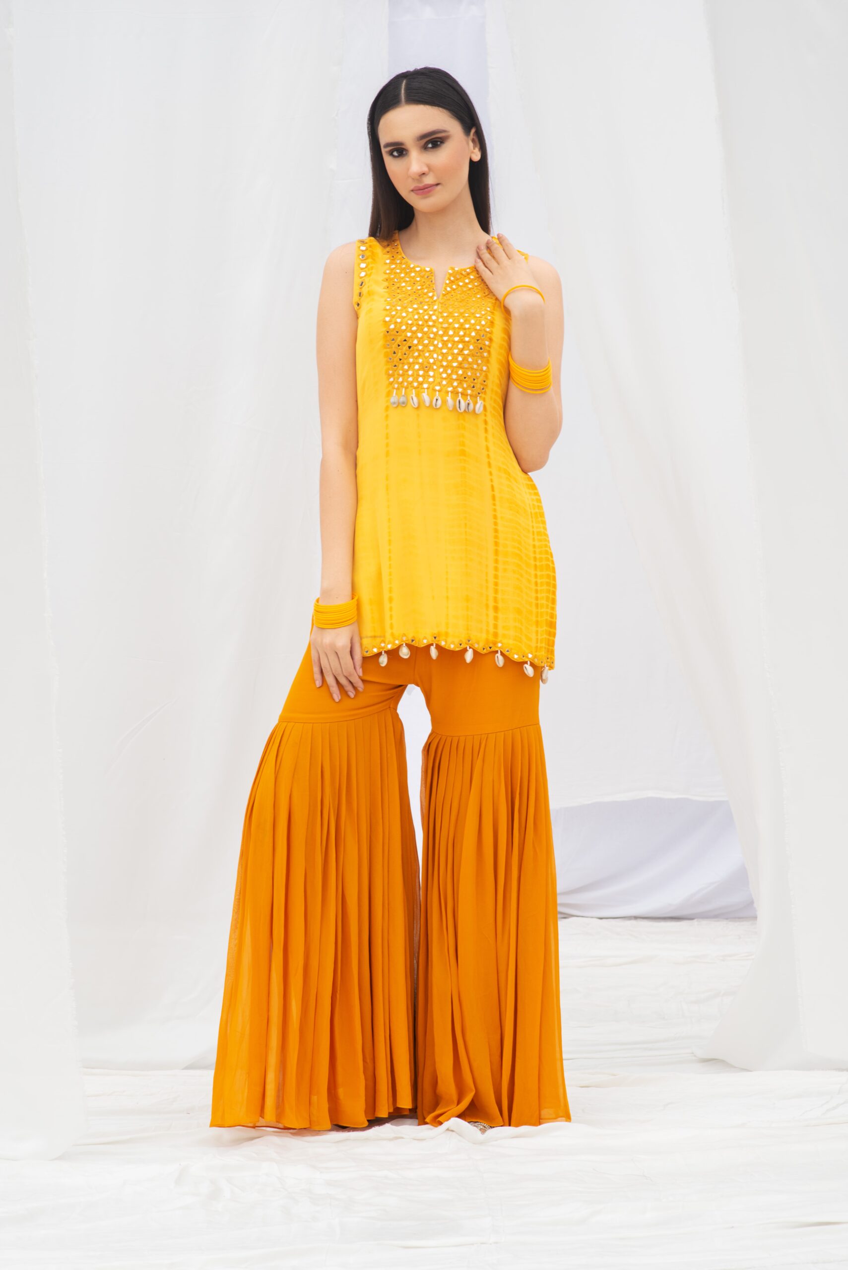 VIBRANT SHORT KURTA PAIRED WITH A STYLISH GARARA AND DUPATTA.
