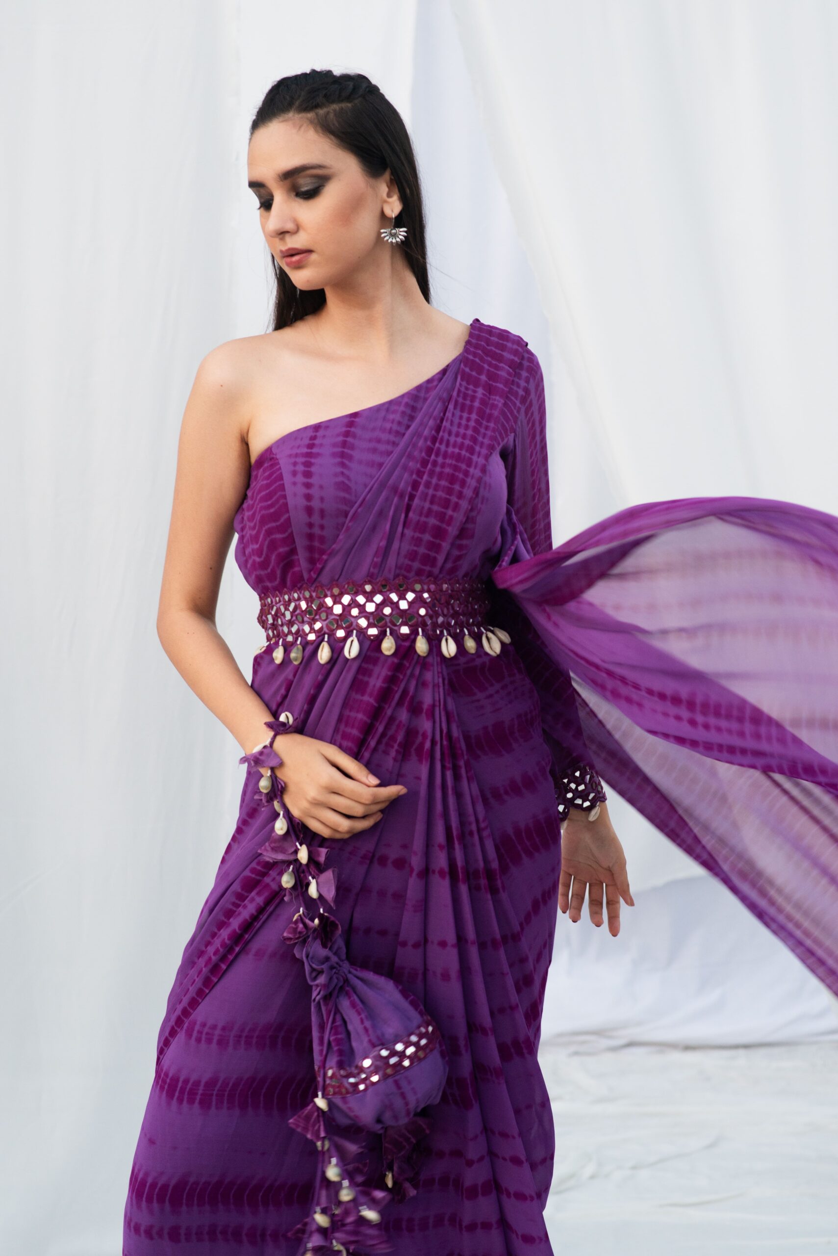 ONE SHOULDER SAREE WITH A MODERN BELT.